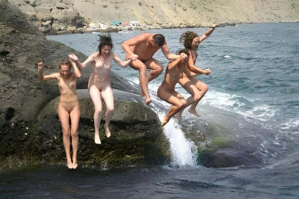 Mens and girls nudists on a beach - Naturism and nudism