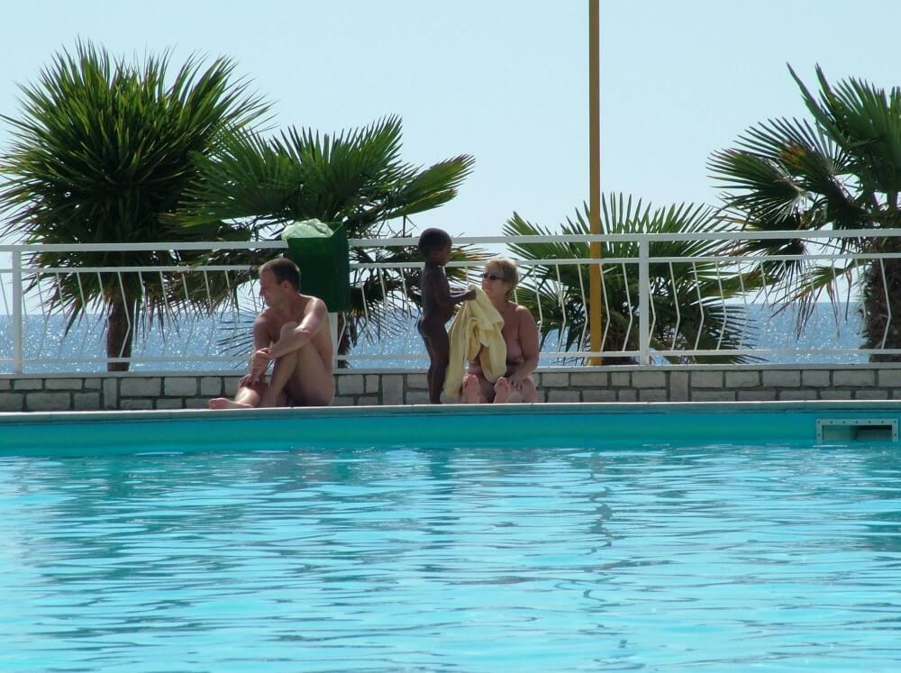 Photo of naturists in an outdoor pool - Naturism and nudism